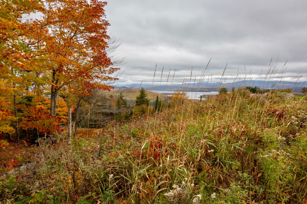Cloudy skies and fall foliage, Rangeley Lakes in the distance